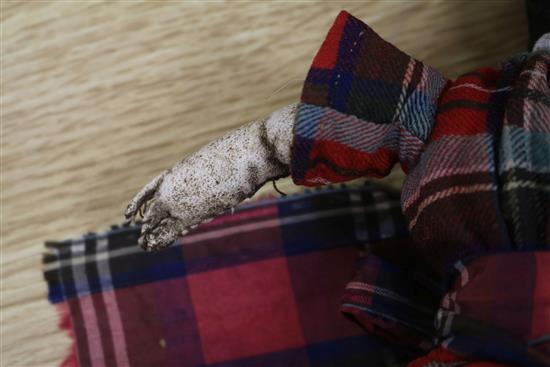 A Victorian doll wearing a tartan dress